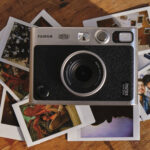 Fujifilm-Instax-Mini-Evo-Camera-lying-on-stack-of-photos